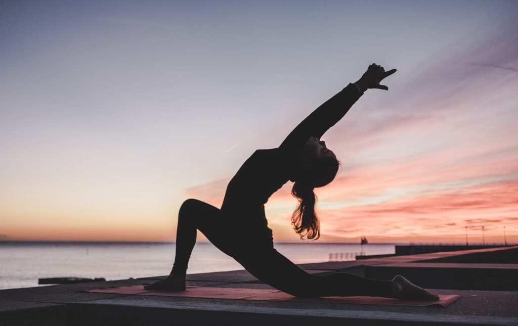 Woman doing yoga outdoors — sustainable weight loss methods